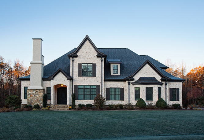 Two story brick house with large chimney feature